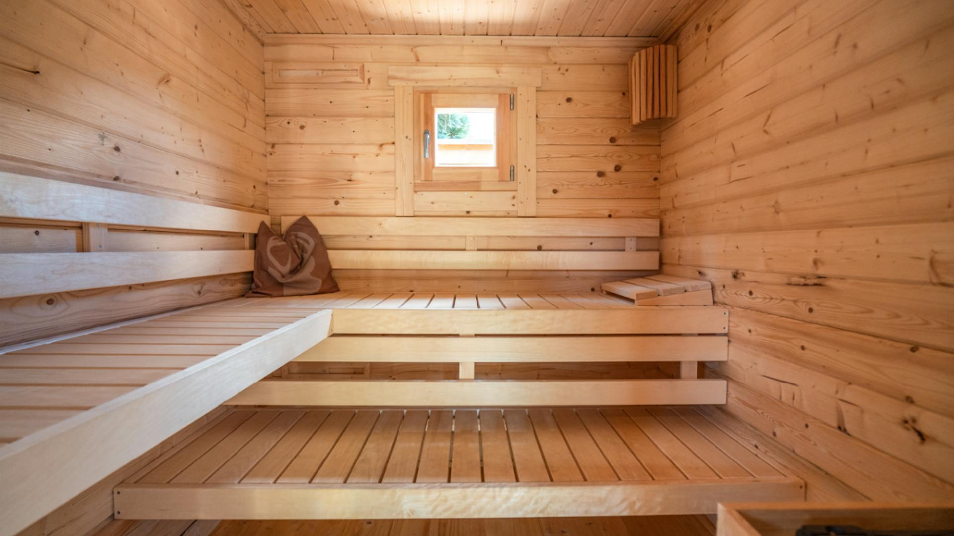 Saunaraum mit kleinem Fenster und drei Liegeflächen