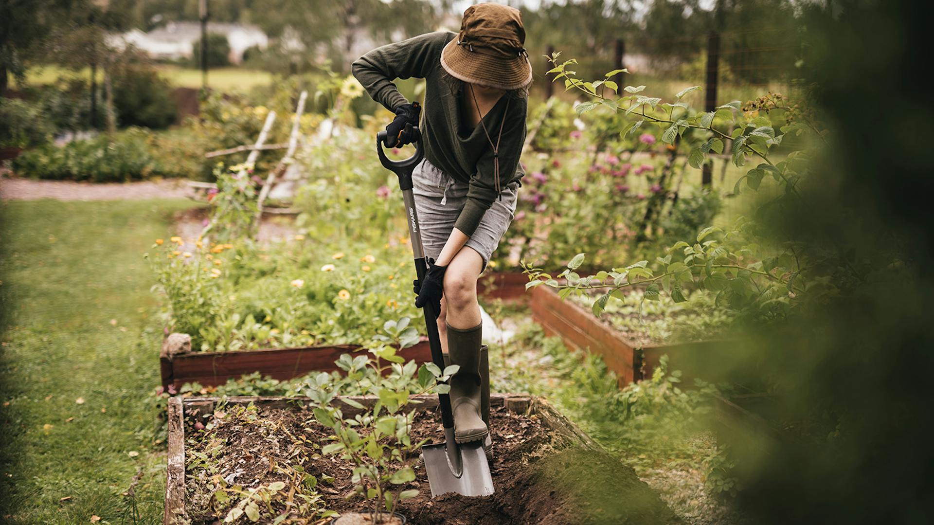 Eine Frau nutzt einen Fiskars Spaten zur Bodenbearbeitung