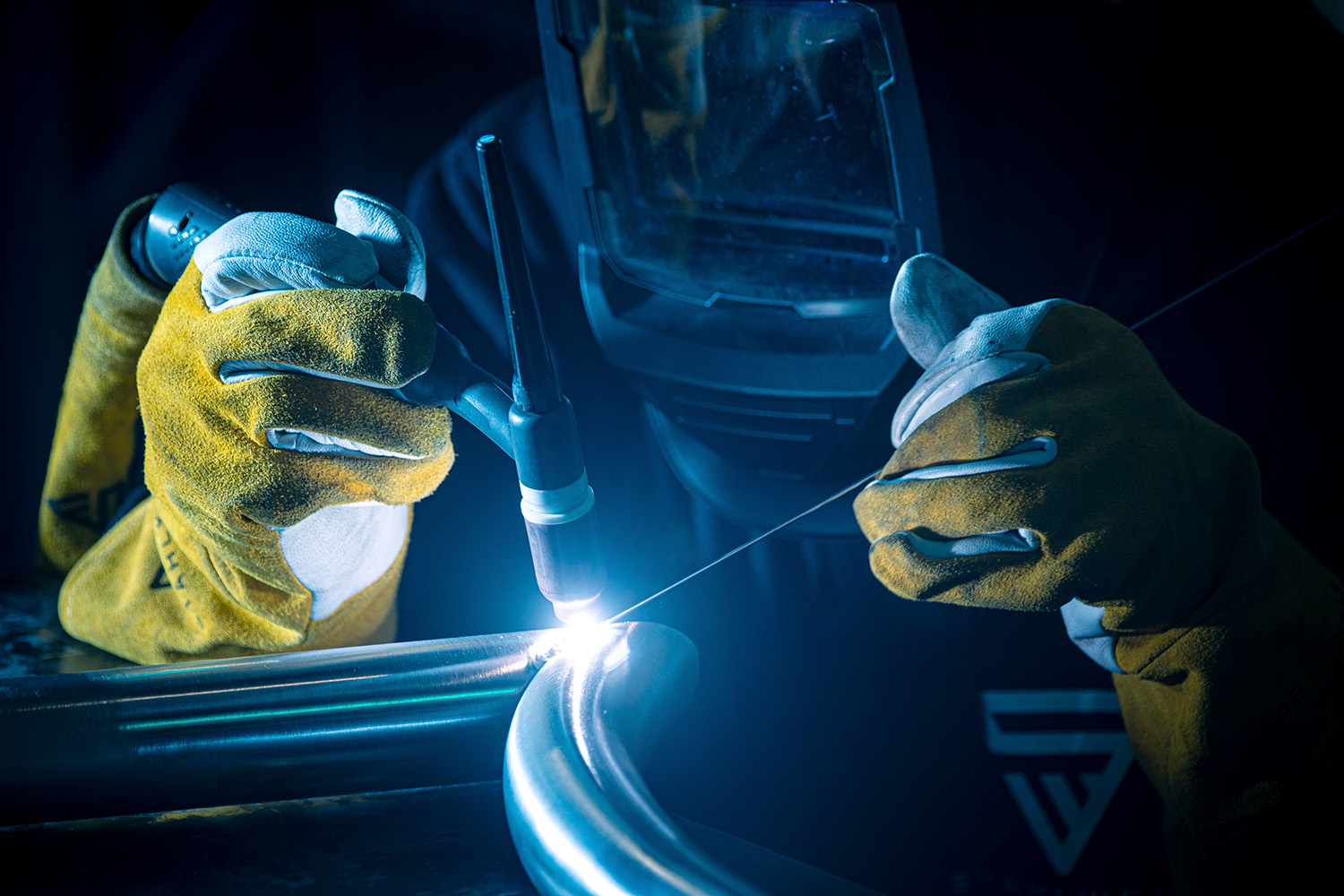 Ein Mann schweißt mit Stahlwerk Schweißdraht